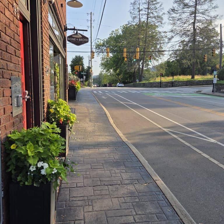 Buffered bike lane along Charlotte Street near Chestnut Street. Lane as wider white lines to provide more distance from Asheville traffic.