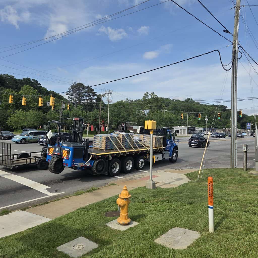 Big rigs and cars passing through Patton Ave and Louisiana Ave intersection in Asheville