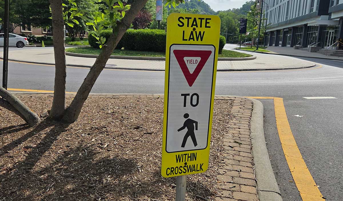 A yield for pedestrian sign along College Street in Asheville.